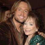 Keith Urban Instagram - There’s unique artists, and I mean truly unique artists, and then there’s the very rare ‘one of one’ unclonable originals. That was THE Miss Loretta Lynn. Bold, fearless, unfiltered, hilarious, smart as a whip, trailblazing (all with a glint in her eye), and gold in her heart. I was honored to have been her date for the 2005 CMT awards. From that night all the way through her 87th birthday bash in 2019 where Miss Loretta asked me to jump out of a cake for her - which I gladly did - she’s been a true believer. It’s hard to quantify what she brought not only to country music, but to millions of people everywhere. A voice that was needed. Subjects and themes nobody else would dare write and sing about. She did it. I’m profoundly grateful for the all too brief time I got to spend with her. Blessings to you and your eternal light Miss Loretta and to all of your family and friends.