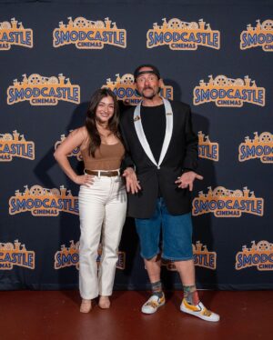 Kevin Smith Instagram - The Jersey Girl came to see JERSEY GIRL! @raquelxcastro paid a visit to my beloved @smodcastlecinemas to cap off a Memorial Day weekend full of shows! On Friday, we showed JAWS as part of the Movies That Made Me series. Then on Saturday night, we watched my flick RED STATE. But Sunday saw a reunion with the little girl who, at age 7, preternaturally played the role of Gertie in my sixth flick. We screened what we were calling JERSEY GIRL: The Snyder Cut, because it was the longest version of the flick ever edited, with an entire first act full of @jlo that got cut out due to post-Gigli hysteria. I haven’t seen any cut of JG since 2006, so it was a trip to see the movie I originally made #bennifer two decades ago. Hopefully, @paramountplus will want to stream it in 2024 for the 20th anniversary. It’s almost an entirely different flick. Also entirely different: Raquel, who’s now about 2 years younger than her cinematic Dad #benaffleck was when we shot it. I was happy to discover our troubled film didn’t ruin Rocky, who grew up to be such a wonderful kid with a great head on her shoulders. I can’t thank her enough for a killer kid performance, as well as for making the trip all the way from L.A. to be at #smodcastle with an ardent audience. It was a lovely weekend (with 3 profitable pre-show auctions, thank you bidders), during which I got to wear a trio of different jackets, as well as my new Smodcastle sneakers made by @1craftypunk! Next up: BABBLE-ON this Saturday and WATCH WITH KEV: @dctheflash on June 15, 16 & 17! Tickets available now at SmodcastleCinemas dot com! Take a trip to Smodcastle, where the movies come to play! #KevinSmith #smodcastlecinemas #raquelcastro #jersey #newjersey #film