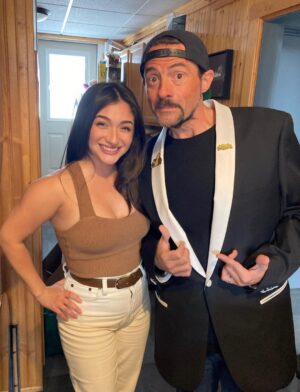 Kevin Smith Instagram - The Jersey Girl came to see JERSEY GIRL! @raquelxcastro paid a visit to my beloved @smodcastlecinemas to cap off a Memorial Day weekend full of shows! On Friday, we showed JAWS as part of the Movies That Made Me series. Then on Saturday night, we watched my flick RED STATE. But Sunday saw a reunion with the little girl who, at age 7, preternaturally played the role of Gertie in my sixth flick. We screened what we were calling JERSEY GIRL: The Snyder Cut, because it was the longest version of the flick ever edited, with an entire first act full of @jlo that got cut out due to post-Gigli hysteria. I haven’t seen any cut of JG since 2006, so it was a trip to see the movie I originally made #bennifer two decades ago. Hopefully, @paramountplus will want to stream it in 2024 for the 20th anniversary. It’s almost an entirely different flick. Also entirely different: Raquel, who’s now about 2 years younger than her cinematic Dad #benaffleck was when we shot it. I was happy to discover our troubled film didn’t ruin Rocky, who grew up to be such a wonderful kid with a great head on her shoulders. I can’t thank her enough for a killer kid performance, as well as for making the trip all the way from L.A. to be at #smodcastle with an ardent audience. It was a lovely weekend (with 3 profitable pre-show auctions, thank you bidders), during which I got to wear a trio of different jackets, as well as my new Smodcastle sneakers made by @1craftypunk! Next up: BABBLE-ON this Saturday and WATCH WITH KEV: @dctheflash on June 15, 16 & 17! Tickets available now at SmodcastleCinemas dot com! Take a trip to Smodcastle, where the movies come to play! #KevinSmith #smodcastlecinemas #raquelcastro #jersey #newjersey #film