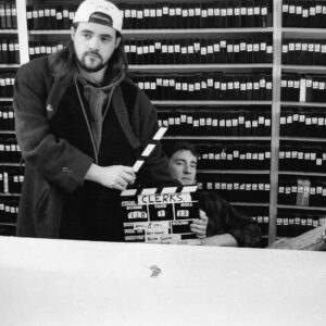 Kevin Smith Instagram - HAPPY CLERKS DAY!
30 years ago from today, CLERKS debuted at the 1994 Sundance Film Festival! That means, if you ever wanted to stop me or my career from happening, youʼd send a Terminator back to this moment in time 3 decades back.

Mercifully, there was no robotic hunter/killer trying to kill me at Sundance that year. The inaugural screening took place at the Holiday Village Cinema in a sold out 150 seater. That was the first time I got to see my first film with a full audience. The sheer thrill of finding out that ideas Iʼd had years prior actually held up to public scrutiny from strangers was intoxicating (but that also might have had something to do with the thin air at the high altitude). 

That first screening started the buzz that powered the next three screenings and a deluge of press about the black and white New Jersey convenience store movie and the director who was going back to work there after the Festival ended.

By our fourth and final Sundance screening at The Egyptian Theater on Main Street in Park City, Clerks was being talked about and written about like it was well worth watching. As he introduced me and the film, Festival head Geoff Gilmore described me in a way that still gets me in the feels when he said “If Kevin Smith didnʼt exist, the Sundance Film Festival wouldʼve had to invent him.”

Mine was a Cinderella-ish or Rocky-like tale that reminded folks anyone can take a shot at their dreams and maybe find a modicum of success - even if theyʼre from New Jersey.

Do you have a dream (one that doesnʼt involve hurting people or animals, destruction or death)?
2024 is the year you move closer to your goal and take your shot on yourself.

Many thanks to Brian, Jeff, Jay, Marilyn, Lisa, Scott, Dave, Kim, Virginia, Donald, Mom, Dad, the Thapars, and everyone else who helped me craft Clerks! Many thanks to Sundance, Mark Tusk, Bob Hawk and John Pierson for guiding a gobsmacked newcomer in his sudden success. And many thanks to you, my friends, for 30 years of continued interest in the Askewniverse adventures of retailing rascals 
Head over to JayAndSilentBob dot com TODAY to shop our anniversary sales!
#KevinSmith #clerks #film