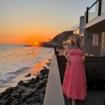 Khloë Terae Instagram - Counting down the hours 💕☀️🌊 @fashionnova wearing penelope maxi dress in coral size medium 🎀 Malibu, California