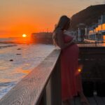 Khloë Terae Instagram - Counting down the hours 💕☀️🌊 @fashionnova wearing penelope maxi dress in coral size medium 🎀 Malibu, California