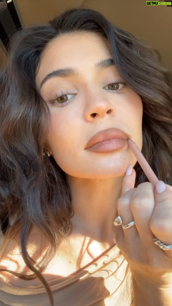 Kylie Jenner Instagram - @kyliecosmetics here’s my favorite new juicy lip combo 💦 🤍 Precision Pout Lip Liner shade ‘Cinnamon’ 🤍 Tinted Butter Balm shade ‘Love That 4 U’ 🤍 Gloss Drip shade ‘Playfully Pink’