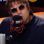 Liam Gallagher Instagram - “Hanging about with 70,000 people and giving it the big one I can do stood on my head” Knebworth 22 out 11th August. Link in bio to pre-order. @bbcradio2