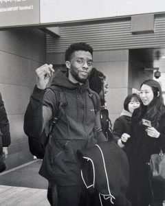 Lupita Nyong'o Instagram - Three years ago today, I experienced a singular pain at the news of @chadwickboseman's death. The confusion was so profound that it took months to trust the feeling of joy again. : This is a photo I took on film at the airport as we arrived in South Korea in 2018. We had just learned to do the baby heart with our fingers. Here Chadwick was adding his suave flare 😊. We spent a glorious 72 hours there, and the memory fills me with so much joy. : Death is hard to understand, maybe even harder to accept. But the love generated from the life he lived will fuel every anniversary marking his absence. : Chadwick may no longer be in our photos, but he will always be in our hearts. Seoul, Korea
