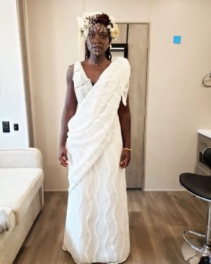 Lupita Nyong'o Instagram - Celebrating @therealruthecarter, #BlackPanther #WakandaForever costume designer(swipe ↔️ for context).

Ruth is all about collaboration and cultural appreciation and here is an example:
:
When I went into my first fitting for #WakandaForever, Ruth was still trying to figure out Nakia's look for Ramonda's funeral. She shared some concept art with me and wanted to hear my thoughts and ideas. I had been in Kenya earlier that year, and my sister Fiona had attended a friend's Rwandan wedding in full Rwandese regalia. I was blown away by how elegant she looked, how gracefully her clothing flowed. I shared the photo with Ruth and she loved it too. So, just like that, it became the basis of inspiration for Nakia's look and this is the final result. Ruth took it and RAN a MARATHON with it!
:
It is one of my favorite costumes of all time. The full look did not make an appearance in the movie (you only see a close-up of my face with the incredible head piece and face paint inspired by the Omo tribe of Ethiopia) so enjoy it with me here.
:
And let's give Ruth all her flowers, for highlighting, preserving, elevating and inspiring afro-historic and afro-futuristic style! Congratulations on the well-deserved #Oscars win for Best Costume in a Motion Picture.