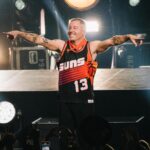 Macklemore Instagram – After a couple off days back in Seattle I landed in phoenix and was greeted by a sizzling 102 degree sun. I decided to dress up like a falcon wrangler. I met people outside that had been waiting since 9:30am to get in.  We hugged, shed some tears and I felt really good in the spirit. The venue was air conditioned and dog friendly prolly. Just had that vibe that if you were a dog they’d let you chill in a hallway and give you a mini Mars bar or some shit. Anyway, I hit the stage in my falcon handling gloves and immediately felt restricted by the big tough leather covering my palms. After the first song they had to go. Bam! Threw them shits. The crowd was loose and nibble as was I, well hydrated and relatively sturdy. I was hitting a lot of spin moves to showcase how hydrated I actually was all while thinking in my head “You still got it my boy”. We laughed and some of my jokes hit. Some didn’t.  Some people yawned. That always throws me off, so if you come to a show and you’re tired please hold that shit in. Anyway, the whole crowd was full of love and they sent us off stage with smiles and daps. Beautiful evening with the Cacti loving folks of Arizona. Next stop…LA for our finale show tonight.