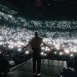 Macklemore Instagram – The Ben Tour USA made its way back home to Washington and a city that I have grown to love over the years: Spokane.  It reminds me of Seattle back in the 80’s before IKEA looking condo’s and tech took over.  There’s a nostalgic Americana vibe from old brick buildings, wide streets, incredible vintage missions, the Spokane river and rustic diners.  Sloane and I put in miles on Lime Scooters riding all over the city and exploring the uncharted terrain.  I have classic core memories shooting the Downtown music video when Sloane was a baby and shutting down multiple city blocks to throw a parade with the people of Spokane.  That same energy was felt from the moment I stepped into the Spokane Arena.  Someone even tracked down the inflatable dog from the music video who made a cameo on stage during Downtown.  11,000 people deep and probably the loudest crowd of the tour.  A true Washington homecoming in one of my favorite PNW places ❤️ Spokane, Washington