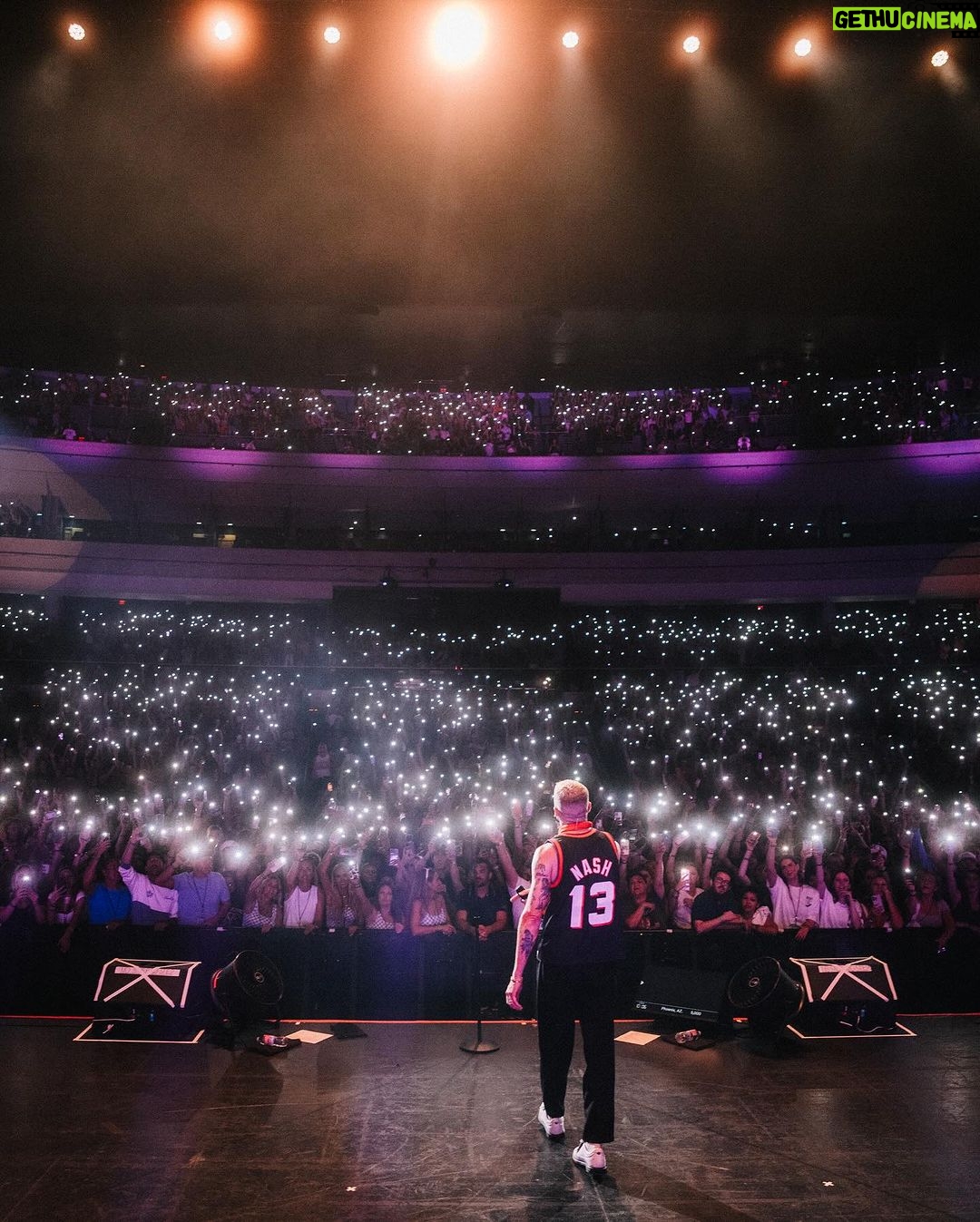 Macklemore Instagram - After a couple off days back in Seattle I landed in phoenix and was greeted by a sizzling 102 degree sun. I decided to dress up like a falcon wrangler. I met people outside that had been waiting since 9:30am to get in. We hugged, shed some tears and I felt really good in the spirit. The venue was air conditioned and dog friendly prolly. Just had that vibe that if you were a dog they’d let you chill in a hallway and give you a mini Mars bar or some shit. Anyway, I hit the stage in my falcon handling gloves and immediately felt restricted by the big tough leather covering my palms. After the first song they had to go. Bam! Threw them shits. The crowd was loose and nibble as was I, well hydrated and relatively sturdy. I was hitting a lot of spin moves to showcase how hydrated I actually was all while thinking in my head “You still got it my boy”. We laughed and some of my jokes hit. Some didn’t. Some people yawned. That always throws me off, so if you come to a show and you’re tired please hold that shit in. Anyway, the whole crowd was full of love and they sent us off stage with smiles and daps. Beautiful evening with the Cacti loving folks of Arizona. Next stop…LA for our finale show tonight.