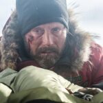 Mads Mikkelsen Instagram - ❄️ #CoolingBreak: Defeated, Overgård lies down next to the woman, takes her hand and prepares to meet his fate. This concludes our cool down series of images from the @mysteryguitarman directed @arcticmovie for now. #MadsFriday #TheOfficialMads