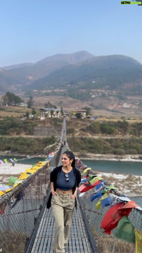 Malavika Mohanan Instagram - Crossing over to the other side of this enchanting valley on what is Bhutan’s longest suspension bridge 🐉🇧🇹 P.S how marvellous are the fluttering prayer flags right?