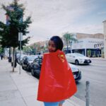 María Gabriela de Faría Instagram - I’m very happy and can’t shut up about it so here’s a compilation of moments after I found out @jamesgunn had invited me to play Angela, The Engineer. 1) I immediately bought a Superman cape at Party City. 2)Surprised my agent at his office with his own cape and champagne. 3-4) My Godmothers got pretty excited and we all pretended to fly. 5) I sent my parents a Superman action figure to Venezuela and that’s how I let them know I got the role. Don’t mind my dad’s words, he loves me. 6) They proceded to send me all of the gifts available with a Superman theme. 7) I walked around town with the Party City cape like a child after a birthday party. 7) Angie ❤️ • • • Estoy muy feliz y no se me quita, así que aquí hay una recopilación de momentos después de que @jamesgunn me invitara a interpretar a Angela, The Engineer. 1) Inmediatamente compré una capa de Superman en Party City. 2) Sorprendí a mi agente en su oficina con su propia capa y champaña. 3-4) Mis Madrinas se emocionaron mucho y por un rato jugamos a que Catha volaba. 5) Le envié a mis papás una figura de acción de Superman a Venezuela y así les hice saber que conseguí el papel. No le hagan caso a las palabras de mi papá, él me ama 🤣 6) Mis papás procedieron a enviarme todos los regalos disponibles con temática de Superman. 7) Caminé por la ciudad con la capa de Party City como un niño después de una fiesta de cumpleaños. 7)Angie❤️