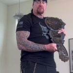 Mark Calaway Instagram - Want a chance to win this 30th Anniversary @wwe Championship Title autographed by yours truly? Head to the link in my bio and purchase your #BSK shirt today! I partnered with @ninelineapparel, a veteran-owned & American-made company, for the design of this shirt. Each purchase enters you in a chance to win this limited-edition title!