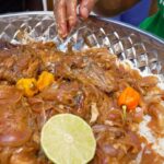 Mark Wiens Instagram - One of the national foods of Senegal 🇸🇳 is “poulet yassa,” chicken fried with a bucket of onions, hot mustard, and lime juice. So good!! #Senegal #SenegaleseFood #Africa