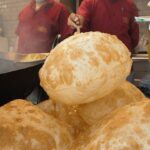 Mark Wiens Instagram - Giant balloon sized 🎈 puris! Pakistani street food with @thefoodranger & @alinhamdani in #Sharjah #PakistaniFood #Dubai 📍 Pakistani Sweets Shop