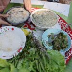 Mark Wiens Instagram - Khao Baue (ข้าวเบอะ) is one of the traditional foods of the Karen people. Similar to a thick rice porridge (except eaten over rice), and this version made with heart of fishtail palm and Isodon ternifolius (ผักอีหลืน) flowers 🌺 Thanks to Mook and Shikomo @mookshilltribecrafts for making this! #MaeHongSon #KarenFood Mae Hong Son, Thailand