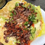 Mark Wiens Instagram - Mexican street food with @mexi_papa_adventures in Los Angeles! @tacoslospoblanosestilotijuana makes fresh masa tortillas, with grilled carne asada 🥩 and chorizo, and salsas. We had the fully loaded quesadilla, must eat when you’re in #LosAngeles #MexicanFood Tacos los Poblanos #1 Estilo Tijuana