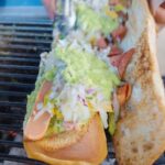 Mark Wiens Instagram - Guatemalan street food 🌭 a hot dog sandwich so big, they call it the “trans-metro!” 🇬🇹 #Guatemala #shucos #streetfood