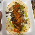 Mark Wiens Instagram - One of the great taquerias of #Tucson, this is the Taco Yaqui, an open faced green chile, cheese, bacon, carne asada, on overlapping flour tortillas. #MexicanFood #Sonora #tacos #Tucson Aqui Con El Nene