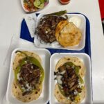 Mark Wiens Instagram - One of the great taquerias of #Tucson, this is the Taco Yaqui, an open faced green chile, cheese, bacon, carne asada, on overlapping flour tortillas. #MexicanFood #Sonora #tacos #Tucson Aqui Con El Nene