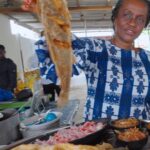 Mark Wiens Instagram - One of the most popular foods in all of Côte d’Ivoire is fried fish with acheke (Attiéké) - made from cassava, and chili sauce 🌶️ 📍 Chez Miss Zahoui, #Abidjan #cotedivoire @bellecotedivoire