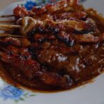 Mark Wiens Instagram - How does he do it all with one hand?? 🇮🇩 Indonesian chicken sate (satay), Madura style - one of the most popular in Indonesia 📍 Sate Ayam Madura Pak Mat #Surabaya #Indonesia with @budi_tarjo Surabaya, Indonesia
