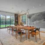 Mary Fitzgerald Instagram – Just Listed – 1375 N. Doheny Dr. – $28,500,000
5 Beds / 9 Baths / 10,613 Sq. Ft. / 17,438 Lot Size
Recently gracing the prestigious cover of Architectural Digest, this estate stands as an embodiment of timeless sophistication, meticulously curated from materials all over the world to create one of the most special homes in all of Los Angeles. Discreetly concealed beyond a privately gated driveway, an oversized motor court is laid with 200+ year-old reclaimed cobblestone from the historic streets of Boston. Experience the epitome of refined living with an open floor plan, double-height ceilings, and palatial steel-framed Crittal sliding glass doors which seamlessly unite the interior/outdoor spaces including a serene pool, covered patio, and verdant lawn. The sensuous chef’s kitchen is an epicurean haven boasting custom bronze-patinated cabinets, top-of-the-line appliances including floating burners by Pitt, and 20 slabs of book-matched Calacatta marble bearing an Rorschach-like allure. The owner’s suite bath, inspired by Jean Michel Frank – a French art deco architect known for his soft, undulating lines – stands as the quintessence of unparalleled elegance and decadence; every square inch has been cocooned in 40 slabs of Calacatta Breccia Capraia, (an impossibly rare marble from Italy that was used throughout Italian churches for hundreds of years) including the steam shower’s built-in chaise lounge to the monolithic tub hewn from a single block of stone, all paired with opulent Waterworks fixtures. Bespoke amenities include an office wrapped in an envelope of reclaimed French Oak, a state-of-the-art theater, wine cellar, gym, recreation room, private library, unrivaled security, and audio/visual integration. Unquestionably the most impressively crafted and composed property available, tailored for the most discerning buyer desiring perfection.
Listed by
@themarybonnet @jasonoppenheim
