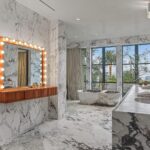 Mary Fitzgerald Instagram – Just Listed – 1375 N. Doheny Dr. – $28,500,000
5 Beds / 9 Baths / 10,613 Sq. Ft. / 17,438 Lot Size
Recently gracing the prestigious cover of Architectural Digest, this estate stands as an embodiment of timeless sophistication, meticulously curated from materials all over the world to create one of the most special homes in all of Los Angeles. Discreetly concealed beyond a privately gated driveway, an oversized motor court is laid with 200+ year-old reclaimed cobblestone from the historic streets of Boston. Experience the epitome of refined living with an open floor plan, double-height ceilings, and palatial steel-framed Crittal sliding glass doors which seamlessly unite the interior/outdoor spaces including a serene pool, covered patio, and verdant lawn. The sensuous chefβs kitchen is an epicurean haven boasting custom bronze-patinated cabinets, top-of-the-line appliances including floating burners by Pitt, and 20 slabs of book-matched Calacatta marble bearing an Rorschach-like allure. The ownerβs suite bath, inspired by Jean Michel Frank – a French art deco architect known for his soft, undulating lines – stands as the quintessence of unparalleled elegance and decadence; every square inch has been cocooned in 40 slabs of Calacatta Breccia Capraia, (an impossibly rare marble from Italy that was used throughout Italian churches for hundreds of years) including the steam showerβs built-in chaise lounge to the monolithic tub hewn from a single block of stone, all paired with opulent Waterworks fixtures. Bespoke amenities include an office wrapped in an envelope of reclaimed French Oak, a state-of-the-art theater, wine cellar, gym, recreation room, private library, unrivaled security, and audio/visual integration. Unquestionably the most impressively crafted and composed property available, tailored for the most discerning buyer desiring perfection.
Listed by
@themarybonnet @jasonoppenheim