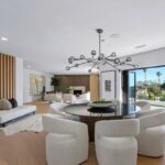 Mary Fitzgerald Instagram - Just Listed In Villa Park - 18541 Valley Dr. - $5,495,000 8 Beds / 8 Baths / 10,329 Sq. Ft. / 39,335 Lot Size Located in Orange County's prestigious Villa Park and set behind private gates on an elevated lot, this newly remodeled contemporary estate offers breathtaking views of the city and Catalina Island. Boasting 8 bedrooms, 8 baths, and over 10,000 sq. ft. of living space on an expansive nearly 40,000 sq. ft. lot, the home comes replete with every amenity necessary for luxe living and top-class entertainment. Enter into a light-filled foyer with double-height ceilings and a wrap-around staircase accentuated by a chandelier. The main level enjoys an open floor plan with flowing spaces accentuated by White Oak flooring. The cozy living area is framed by a wooden feature wall and marble fireplace. Adjacent to this, the dining area is replete with its own wooden accent feature wall, custom-built buffet cabinets, and designer chandelier. The chef's kitchen features a full set of Thermador appliances, custom White Oak cabinetry, leathered granite backsplash and countertops, and a large cascading center island with seating. A spacious breakfast nook with additional storage and views completes the kitchen area, with its own semi-private room with a fireplace perfect for an additional family/TV room. This entire level enjoys access to the sweeping yard with a resort-style pool and spa with smart controls, a Cantilever pergola with a rainfall feature, and a built-in BBQ, all enjoying more gorgeous views. The split-level primary suite enjoys high ceilings, a sitting area, fireplace, private balcony with sprawling unobstructed views, his-and-her closets, and a breathtaking spa-like bathroom with dual vanity, touchless heated smart toilet, large walk-in steam shower, freestanding bathtub, and sauna. Additional amenities include a secondary owner's suite with a large bathroom, a 1,000 sq. ft. theater with 11.2 Dolby Atmos system, two office spaces, a gym with massage room (could be wine or cigar room), a 4-car garage, and a 20-car motor court. Listing Agents: @alexanderhuerta_ @jasonoppenheim