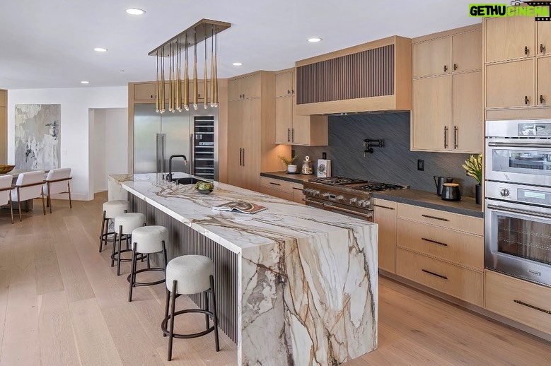 Mary Fitzgerald Instagram - Just Listed In Villa Park - 18541 Valley Dr. - $5,495,000 8 Beds / 8 Baths / 10,329 Sq. Ft. / 39,335 Lot Size Located in Orange County's prestigious Villa Park and set behind private gates on an elevated lot, this newly remodeled contemporary estate offers breathtaking views of the city and Catalina Island. Boasting 8 bedrooms, 8 baths, and over 10,000 sq. ft. of living space on an expansive nearly 40,000 sq. ft. lot, the home comes replete with every amenity necessary for luxe living and top-class entertainment. Enter into a light-filled foyer with double-height ceilings and a wrap-around staircase accentuated by a chandelier. The main level enjoys an open floor plan with flowing spaces accentuated by White Oak flooring. The cozy living area is framed by a wooden feature wall and marble fireplace. Adjacent to this, the dining area is replete with its own wooden accent feature wall, custom-built buffet cabinets, and designer chandelier. The chef's kitchen features a full set of Thermador appliances, custom White Oak cabinetry, leathered granite backsplash and countertops, and a large cascading center island with seating. A spacious breakfast nook with additional storage and views completes the kitchen area, with its own semi-private room with a fireplace perfect for an additional family/TV room. This entire level enjoys access to the sweeping yard with a resort-style pool and spa with smart controls, a Cantilever pergola with a rainfall feature, and a built-in BBQ, all enjoying more gorgeous views. The split-level primary suite enjoys high ceilings, a sitting area, fireplace, private balcony with sprawling unobstructed views, his-and-her closets, and a breathtaking spa-like bathroom with dual vanity, touchless heated smart toilet, large walk-in steam shower, freestanding bathtub, and sauna. Additional amenities include a secondary owner's suite with a large bathroom, a 1,000 sq. ft. theater with 11.2 Dolby Atmos system, two office spaces, a gym with massage room (could be wine or cigar room), a 4-car garage, and a 20-car motor court. Listing Agents: @alexanderhuerta_ @jasonoppenheim