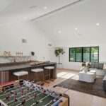 Mary Fitzgerald Instagram - Just Listed In Villa Park - 18541 Valley Dr. - $5,495,000 8 Beds / 8 Baths / 10,329 Sq. Ft. / 39,335 Lot Size Located in Orange County's prestigious Villa Park and set behind private gates on an elevated lot, this newly remodeled contemporary estate offers breathtaking views of the city and Catalina Island. Boasting 8 bedrooms, 8 baths, and over 10,000 sq. ft. of living space on an expansive nearly 40,000 sq. ft. lot, the home comes replete with every amenity necessary for luxe living and top-class entertainment. Enter into a light-filled foyer with double-height ceilings and a wrap-around staircase accentuated by a chandelier. The main level enjoys an open floor plan with flowing spaces accentuated by White Oak flooring. The cozy living area is framed by a wooden feature wall and marble fireplace. Adjacent to this, the dining area is replete with its own wooden accent feature wall, custom-built buffet cabinets, and designer chandelier. The chef's kitchen features a full set of Thermador appliances, custom White Oak cabinetry, leathered granite backsplash and countertops, and a large cascading center island with seating. A spacious breakfast nook with additional storage and views completes the kitchen area, with its own semi-private room with a fireplace perfect for an additional family/TV room. This entire level enjoys access to the sweeping yard with a resort-style pool and spa with smart controls, a Cantilever pergola with a rainfall feature, and a built-in BBQ, all enjoying more gorgeous views. The split-level primary suite enjoys high ceilings, a sitting area, fireplace, private balcony with sprawling unobstructed views, his-and-her closets, and a breathtaking spa-like bathroom with dual vanity, touchless heated smart toilet, large walk-in steam shower, freestanding bathtub, and sauna. Additional amenities include a secondary owner's suite with a large bathroom, a 1,000 sq. ft. theater with 11.2 Dolby Atmos system, two office spaces, a gym with massage room (could be wine or cigar room), a 4-car garage, and a 20-car motor court. Listing Agents: @alexanderhuerta_ @jasonoppenheim