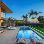 Mary Fitzgerald Instagram - Just Listed in Manhattan Beach - 1001 1st St. - $29,900,000 6 Bed / 9 Bath / 9,479 Sq. Ft. The most impressive and high-quality Contemporary estate ever built in Manhattan Beach, featuring panoramic ocean views from every room. After a laborious multi-year build, this approximately 9,500 sq. ft. showstopper seamlessly fuses glass, cedar, and concrete into a triumphant architectural tour de force with a sense of permanence and grandeur. Integral to the structure and aesthetic of the home, the scalloped concrete walls seen on the exterior and interior walls resemble an undulating wave-like texture accomplished by custom milled formwork which complement the surrounding Pacific landscape. Custom cedar clads the remaining walls and ceilings, bringing warmth and visual impact throughout the sleek space. Double-height ceilings and oversized automated Otiima pocketing doors and windows create a sense of expansion within, as the home seamlessly unfolds into an extensive beautifully landscaped outdoor terrace and pool/spa perfect for California living. An additional shaded patio with fireplace is created by the deep cedar overhangs from the upper floor and the roof. Generously nestled on an extra-wide corner lot, the home is replete with 6 bedrooms plus an additional office/nursery, 9 bathrooms, home theater, game room, wine cellar, wet bar, and gym, with architecture by Laney LA. Additional amenities include 48 solar panels with Tesla Powerwalls, elevator, 14 zone A/C technology platform system, Control4 home automation, and 3-car garage with additional driveway parking. An exceptionally rare opportunity to own a meticulously crafted beach estate with soul and sophistication.