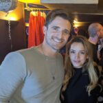 Matthew Hussey Instagram - This first picture was taken the night Audrey and I met! How crazy is it that we have a picture from the night we met! A friend of Audrey’s randomly took the photo of us, and then sent us the photo 2 years later when they found it on their phone and realized we had become serious! We’d literally met for the first time an hour before this picture was taken. Just two lil babies flirtin’. I wasn’t even going to go to this party. I just happened to be back in London for Christmas that week and a friend of mine persuaded me to go. When we were on the way, that same friend told me: “There is a girl who will be there that all the boys are in love with, and we’re all afraid you’re going to steal her”. He didn’t tell me who it was when we walked in, but within minutes I knew. I was glued to the tv in the bar at the beginning of the evening because there was this big boxing match on that night, but I kept making eye contact with her the whole time. She sidled up next to me, started watching the tv, and then asked me a question about the boxing (something she has never shown an interest in since). And that was that. We talked for 8 hours that night (literally). David Brookes once said: “A marriage is a 50 year conversation. Have I met a person who I can talk to for that length of time?” I have, which is why I asked this incredible human being to marry me. I can’t believe I get to build a life with someone as amazing as you. I’m stupidly excited to do it all with you—to be grown ups and do all the grown up things, while deep down staying just two lil babies flirtin’. Happy Valentine’s Day @theaudreyhussey. I love you forever. ❤️