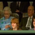 Matthew Lewis Instagram – This was as close as I ever got to Her Majesty. I, along with a few of the old gang, were invited to sit with her at the palace while we watched a little film we made for her 80th birthday. I think she liked it. Quite an honour for a northern monkey sporting a black eye, let me tell you. The second image is a picture hanging in my office because I’m a weirdo. 

Truth be told, anyone who knows me, knows me to be a contradiction. Everything about me screams republican (small-r, not the dreadful elephant kind). I think monarchy is mad, in this or any century. Even writing this all seems, frankly, a bit silly. And yet… and yet. For better or worse, so much of my identity is wrapped up in it, has always been. More so living abroad these last few years, and with all the “leaders” the UK has been burdened with, HM was a constant, part of an intangible sense (illusion?) of stability. 

I can’t think of much else to say, nor why I even felt compelled to say anything at all but I guess, after a lifetime of service to her country, I hope that she may now rest in peace. GSTK.