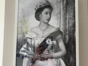 Matthew Lewis Instagram - This was as close as I ever got to Her Majesty. I, along with a few of the old gang, were invited to sit with her at the palace while we watched a little film we made for her 80th birthday. I think she liked it. Quite an honour for a northern monkey sporting a black eye, let me tell you. The second image is a picture hanging in my office because I’m a weirdo. 

Truth be told, anyone who knows me, knows me to be a contradiction. Everything about me screams republican (small-r, not the dreadful elephant kind). I think monarchy is mad, in this or any century. Even writing this all seems, frankly, a bit silly. And yet… and yet. For better or worse, so much of my identity is wrapped up in it, has always been. More so living abroad these last few years, and with all the “leaders” the UK has been burdened with, HM was a constant, part of an intangible sense (illusion?) of stability. 

I can’t think of much else to say, nor why I even felt compelled to say anything at all but I guess, after a lifetime of service to her country, I hope that she may now rest in peace. GSTK.