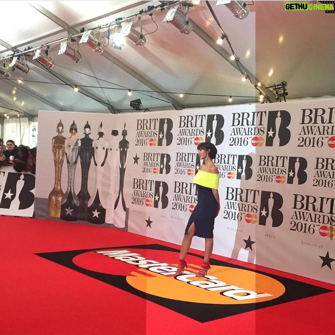Maya Jama Instagram - She’s hosting The Brit Awards💫 Realised I don’t post as much work stuff on here as I should but I wrote down a list of goals as a presenter as soon as I left my retail job and this was the final one I had to tick off🥹 To say 16year old me wouldn’t believe it would be a lie, every single goal I wrote down I knew was possible I just had no idea when or how, self belief & prayer is so crucial, if you believe it you can achieve it as cliche as that is, looking back at it all got me emosh, there’s beauty in the journey.. & here we are 🙏🏽 Pic 2 is the first time I ever attended at 21 and I hadn’t learnt how to pose on red carpets so my fist was clenched behind my back from nerves 😂 Pic 3 is the first time I hosted the red carpet show in 2018 Video is me doing interviews for the Critics choice performances in 2016 Hosted the pre show a few years in a row, last minute stint on the main show & nowww il see you on March 2nd with the guyssss 👋❤️