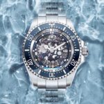Michael Blakey Instagram - Timepiece Thursday ! You have to love this amazing creation from @artisansdegeneve It’s called "Grand Bleu" and is a tribute to the ocean's immense depths. It has a fully skeletonized movement and dial along with a sapphire disc, various hues of blue from the ceramic bezel to the plate. Go and follow @artisansdegeneve and find out more about their amazing work. ~~~~~~~~~ In it to win it! ~~~~~~~~~ Personalized by Artisans de Genève, which is not affiliated or authorized by ROLEX SA. A customization option available solely for private individuals who own a Rolex for their personal use only.