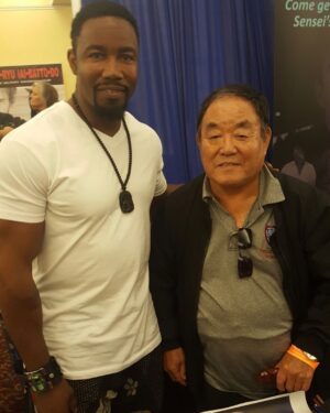 Michael Jai White Instagram - Yesterday the Martial Arts world lost a giant with the passing of Sensei, #FumioDemura. He was one of the world’s highest ranking Karateka, known as “The Real Mr. Miyagi.” He trained every day and was as humble as he was exalted! I had the honor or training with him and casting him as an elite VIP Guest in Blood And Bone’s final fight. As a child, I bought and studied all of his books. I speak for many when I say, he will be terribly missed!  OSU! Sensei, Demura! #martialarts #sensei #honor #karate #karateka #fumiodemurasensei #michaeljaiwhite