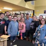 Mike Rowe Instagram - Sunday, outside of @BelAirLiquors there was thunder and lightning and an inch of rain falling every 30 minutes. Inside, there were over 100 well-mannered people with excellent taste in whiskey, waiting patiently in line to shake my hand and grab a photo. What do you say to people who brave a hurricane to say hello and buy a signed bottle of your grandfather’s whiskey? Well, if you’re me, you say “thanks,” as sincerely as you can, over and over again. Among others was the Pelletier family, all 14 of them. This is the largest family I’ve ever posed for a photo with, and I’m not even sure they were all represented. Once you show up with 14, you have to assume there’s another 3 or 4 in the wings, right? I don’t remember each of their names, but I think it was young Jake (?) who made a crab out of stones, mounted it in a very tasteful frame, and presented it to me as a gift. Thanks, Jake. Very thoughtful. I’ll hang it in a place of prominence upon my return. I met Nick Berte, who built a very cool Double Whiskey Barrel Liquor Cabinet, that opens and closes with the touch of a remote control. The store is raffling it off at the annual Maryland Italian Festival to raise money for charity. I met Mike Griffith, who is a Maryland State Delegate for District 35B. I know this because he gave me his business card, which I I’ll hang on to. You never know when you need the services of a state delegate, right? And then there was Jon, a Baltimore County Detective who was shot four times by a creep with an AR-15 just a few months ago. Jon survived, happily, and was released from the hospital not long ago. His wounds are very serious, but he stood in line like all the others, thanked me for supporting first responders, and gave me a patch that said, “Don’t Die Easy.” What do you say to a guy who risks his life to serve and protect you, gets damn near killed, and then comes out on a rainy Sunday to shake your hand? If you’re me, you say “thanks,” as sincerely as you can, over and over again. I proprietor, Larry Dean, and his hardworking family. Big thanks to all of you guys, for making it happen. And congratulations for having such awesome customers. Till next time. Belair Md