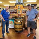 Mike Rowe Instagram - Sunday, outside of @BelAirLiquors there was thunder and lightning and an inch of rain falling every 30 minutes. Inside, there were over 100 well-mannered people with excellent taste in whiskey, waiting patiently in line to shake my hand and grab a photo. What do you say to people who brave a hurricane to say hello and buy a signed bottle of your grandfather’s whiskey? Well, if you’re me, you say “thanks,” as sincerely as you can, over and over again. Among others was the Pelletier family, all 14 of them. This is the largest family I’ve ever posed for a photo with, and I’m not even sure they were all represented. Once you show up with 14, you have to assume there’s another 3 or 4 in the wings, right? I don’t remember each of their names, but I think it was young Jake (?) who made a crab out of stones, mounted it in a very tasteful frame, and presented it to me as a gift. Thanks, Jake. Very thoughtful. I’ll hang it in a place of prominence upon my return. I met Nick Berte, who built a very cool Double Whiskey Barrel Liquor Cabinet, that opens and closes with the touch of a remote control. The store is raffling it off at the annual Maryland Italian Festival to raise money for charity. I met Mike Griffith, who is a Maryland State Delegate for District 35B. I know this because he gave me his business card, which I I’ll hang on to. You never know when you need the services of a state delegate, right? And then there was Jon, a Baltimore County Detective who was shot four times by a creep with an AR-15 just a few months ago. Jon survived, happily, and was released from the hospital not long ago. His wounds are very serious, but he stood in line like all the others, thanked me for supporting first responders, and gave me a patch that said, “Don’t Die Easy.” What do you say to a guy who risks his life to serve and protect you, gets damn near killed, and then comes out on a rainy Sunday to shake your hand? If you’re me, you say “thanks,” as sincerely as you can, over and over again. I proprietor, Larry Dean, and his hardworking family. Big thanks to all of you guys, for making it happen. And congratulations for having such awesome customers. Till next time. Belair Md