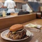 Mike Rowe Instagram - Yesterday, in Oklahoma City, I ate an onion burger at the Sun Cattle Co. It was without a doubt, the best onion burger I’ve ever had, and quite possibly, the best hamburger ever made. It was called The Big Jack, and I had mine with cheese. Onion burgers are an Oklahoma thing, made popular during the Depression when meat was hard to come by. Today, it's a pile of fresh ground beef with lots of onions mixed in. Big Jack is the kid in the cowboy hat, and the double burger is named for him. Jack’s not that big yet, but I suspect he will be, someday soon. His little sister is Ruby, and their dad is Matt. As you can see, they appear to have fallen off the cover of Modern Cowboy. Matt just opened the restaurant with his old buddy Russ, and I think they’ve got a winner. The beef is terrific, and Matt is committed to providing what the hipsters call a “farm to table” experience. He doesn’t call it that, of course. He calls it, “the way people were intended to eat.” In other words, Matt and Russ want you to know where your food comes from – in this case, right down the road, from The Sun Cattle Company that Matt owns and operates. They also want to honor the animals who made the ultimate sacrifice for your dining pleasure. Case in point - #27. The first cow to be served at their new restaurant, who looks over all who enter. A tip of the hat to them all… . . . #Oklahoma #suncattleco #restaurant #onionburger #hamburger Oklahoma City, Oklahoma