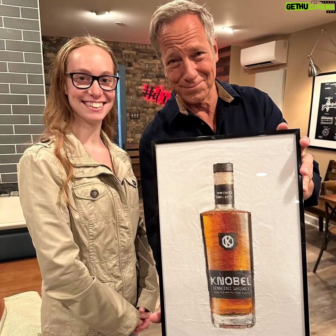 Mike Rowe Instagram - Big thanks to @drug_city_liquors in Dundalk for hosting a Meet and Greet. And an even bigger thanks to the 200 whiskey aficionados who grabbed a photo with yours truly, along with a signed bottle of Knobel Tennessee Whiskey. I was humbled, as always, by your presence, as well as your presents. Consider this cross-stitch from Amanda. Seriously, zoom and look closely at her handiwork. Amanda, aside from being a talented cross-stitcher, is a chemist, and a waitress. She told me that cross-stitching was cool again, and very relaxing. Maybe I’ll try it one day? But probably not, as I am not that cool. Amy Cleaver wanted me to know we might be related. She brought a photo that featured a man she claimed was her Uncle Joe Hergenrather, who also happened to be my second cousin of mine, God rest his soul. Not that I doubted her, but after stopping by my parent’s place and consulting the extensive genealogical tome comprised by my Aunt Betty, it appears Amy was telling the truth. We are in fact related. Proving once again, you never know who you’re going to run into at a whiskey bottle signing. Get a load of Gabe Brooks. Gabe is a former undercover cop in Baltimore who now works for the Bureau of Alcohol, Tobacco, and Firearms. I know this because he gave me an ATF Challenge Coin, and promised to make sure Knobel was properly registered. (It is.) And then there was Bill Pearce. He then presented me with a terrific print from a local artist named Sam Robinson, who captured "The Manor Race," one of the steeplechase races held every year in Monkton, which Bill’s family started 112 years ago. Bill knew my dad was having a birthday tomorrow, and that my mother was crazy for horses. So, he wanted them to have it, and asked me to give it to them with his regards. I did, and they were delighted. A lovely gift, on this, the 63rd anniversary of their nuptials. So many other nice people, with so many stories to tell. Thanks for coming out, very much. If you couldn’t make it, you can order a bottle online, a portion benefits the @mikeroweWORKS. Link in bio. Cheers! Dundalk, Maryland