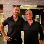 Mike Rowe Instagram - I was in Scottsdale yesterday, replenishing my electrolytes at a bar when a man introduced himself. “My name is Sy, and you probably won’t remember this, but we met on the streets of SF in 2007.” “Of course,” I said. “I’ll never forget that day.” Sy laughed. “You were kind of a smart aleck back then, too.” “I guess some things never change,” I said. With that, Sy opened a small notebook and removed a piece of folded looseleaf from the inside flap. “Here,” he said. I looked at the paper and recognized my signature, along with my trenchant bon mot, and wondered why this man would carry it around for 17 years. “I have no idea why I asked for your autograph in the first place. I mean, I liked Dirty Jobs, but I’ve never asked anyone for their signature before, or since. Isn’t that strange?” I nodded and agreed. It did seem strange, but not nearly as strange as what happened next. The bartender, a tall guy named Kenny asked me if I’d care for another. “Sure, and whatever Sy here is having.” When Kenny returned with our drinks he said, “You probably won’t remember this Mike, but we met back 2007.” “Did you say 2007?” “Yep.” I looked at Sy and said, “Do you guys know each other?” Both men shook their heads. Kenny continued. “You were in a bar on Mackinac Island. You guys were having a big night.” I asked, “Were you a bartender back there?” “No, I was just a guy who grew up watching Dirty Jobs.” “That’s quite a coincidence. Two guys in a random bar, both of whom met me 17 years ago. I wish you’d taken a picture.” “Why is that?” asked Kenny. “Because it would be statistically impossible if both of you had evidence of our meeting.” “Not quite impossible,” said Kenny. With that, he pulled out his phone and started scrolling. 30 seconds later the evidence was downloaded from the cloud. “There we are,” said Kenny. “That’s me crouched down in front of everyone. And that’s you, in the plaid shirt drinking a beer.” It’s moments like these that make me wonder about the belief held by so many that everything happens for a reason. Personally, I’m still a guy who believes in coincidence…but not as much as I did before Sy and Kenny brought the receipts.