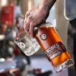 Mike Rowe Instagram - Hi Roy I bring you good tidings of great joy. Or at least, some pretty good news. After a long and protracted delay, we now have in our storeroom a modest supply of Knobel Barrel Strength Whiskey. It's awfully good, especially with a single cube, but be advised, it packs a punch. 121 proof, last I checked. Online proceeds benefit the @mikeroweworks Foundation, which, as you may have heard, is giving away a million dollars in our next round of scholarships. Applications will be accepted at the end of the month, at mikeroweWORKS. But you don't have to wait that long for a snort, at knobelspirits.com (link in bio.) Mike PS. The person attached to the hand in the photo is not me. While I have nothing against tattoos, I don't have any. But if I did, I'd be open to, or at least intrigued, by the notion of the word "SLOWHEART" festooned upon flesh beneath my left pinky. It seems like a good indicator of a healthy cardiovascular system, or maybe, a sign of prudence. Regardless, the hand in question is gripping some very good whiskey.
