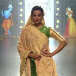 Mugdha Godse Instagram - Loved walking for this beauty ❤️❤️❤️ Posted @withregram @gaurangofficial Graceful footsteps, One after another, Elegance all around, In the epitome of beauty, We knit in threads bound, In Handwoven Kanjeevaram Silk, a Lehenga twirls, In its own gold. A Banarasi Bandhani dupatta, folds.. They speak to us in whispers, Darling, what's life without some glitter! @littlegaurang @gaurangmen @gauranglondon @gaurangofficialdelhi @indian.emporium @aveindiadesign.Newyork @aveindiadesign.bangalore @vayaweavingheritage #Gaurang #GaurangShah #ShahGaurang #LakmeFashionWeek #Eternal #grace #silence #love #be #divine #happiness #workmode