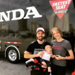 Nathan Kress Instagram - I'd say Rosie's first trip to an @indycar event was a smashing success! Even made a friend out of 2017's Indy 500 winner Takuma Sato. Turns out he's super good at making babies smile! Also I got to take a lap in an Indycar at the Long Beach Grand Prix, but honestly that pales in comparison to this flippin BABY. Acura Grand Prix of Long Beach