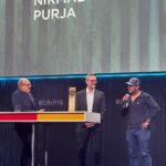 Nirmal Purja Instagram - HUMBLED AND GRATEFUL. Thank you to ISPO and the German Sustainability Awards for the ISPO Cup Award. I am very proud to be the recipient of this honour, both for my achievements in mountaineering and more importantly, for the work the Nimsdai Foundation has been undertaking. The Foundation was set up to give back. To help those in need across all the Big Mountain coms like the Big Mountain Clean Up aim to protect the sacred mountains for the next generation by helping to removing the waste that has built up over decades, and by making the mountain safer by removing old ropes, which pose a danger to climbers. But the @nimsdai_foundation does more than just this, it helps with emergency funds like the current Nepal Earthquake Appeal and previous Pakistan Flood Appeal – helping to get vital support to those that need it on the ground via our in-country networks. It also helps with educational projects and providing schooling and helps to get veterans into the mountain as a rehabilitative force for good. Our next big project is already in the works, a Porters Lodge at Lobuche, Nepal. Porters are the unsung heroes of the mountains, carrying bags, gear and supplies up and down the trails. The Porters Lodge will be specially designed, providing somewhere to rest for the night, as well as a community hub with a café for trekkers, Sherpas and Porters to use. We believe that by doing our bit, and working together, we can create positive change. We only have one home, the Earth. To achieve our big plans we need like-minded individuals and corporate game changers to work with us. Nothing is impossible when we work together. Finally big shoutout out to everyone who’s been doing their best to protect our home by actioning and not just talking 🙌🏽🙏🏽❤️ #nimsdaifoundation #GermanSustainabilityAwards #nimsdai #14peaks #14peaksnothingisimpossible #achieveyournewpossible #alwaysalittlehigher #BigMountainCleanUp #Lobuche #DNP16 #Nachhaltigkeitspreis #Nachhaltigkeitstag @nachhaltigkeitspreis @ispo.acceleratingsports