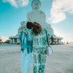 Noorin Shereef Instagram - Standing in awe beneath the watchful gaze of the majestic Big Buddha @fahim_safar 🩵 #phuketstories #phuketstories Travel partner @milaanholidays @fayaz_milaan Video @arun_sathyan_n Wearing @streetlifemens.store @feather_calicut Styling @ashi_ashz Travel curator @anarcelebritymanagement