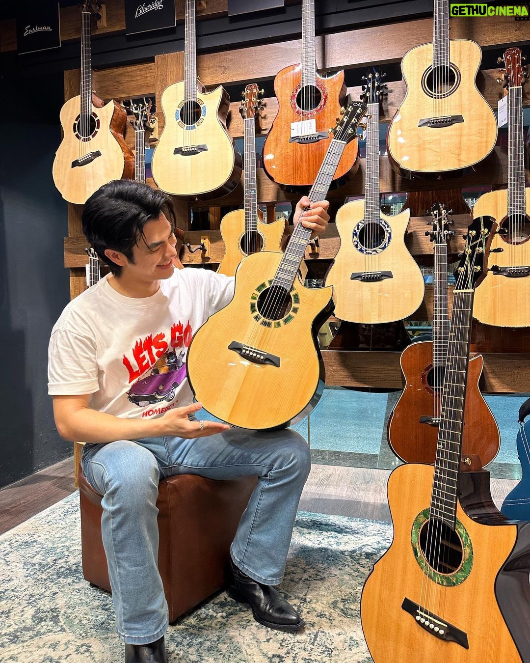 Phakphum Romsaithong Instagram - ,,, อยู่ Singapore 3 วัน มาร้านกีต้าร์ครบ 3 วัน และ ตัดสินใจไม่ได้ว่าตัวไหนดีจนนาทีสุดท้าย 😅,,, มาทำงานที่Singapore รอบนี้ ตาไวเหลือบไปเห็นว่าที่พักอยู่ใกล้กับตึกที่มีร้านกีต้าร์อยู่ที่ผมเคยมาตามหา Vintage Fender เมื่อปีก่อน (ความเจ๋งของ Singapore คือ Shoppingง่าย ที่นี่มักจะรวมเอาของชนิดเดียวกันมาไว้ในตึกเดียวกัน) พอถึงโรงแรม สิ่งแรกที่ทำ คือ ชวนน้องไปเดินร้านกีต้าร์เผื่อน้องจะสนุกเหมือนที่เราชอบทำ กะว่าจะไปหากีต้าร์ ต่อค่อแบบ 12 Frets Joint Back&Maple อยากได้แบบฟีล Traditional Vintage Sound ไว้เล่น Blues เพราะๆ เผื่อฟลุ๊คเจอ ลองไปลองมาอยู่ 4-5 ร้าน 10กว่าตัว ก็ดันมาตกหลุมหลงใหลที่ตัว Sound Hole สีเขียว กีต้าร์สัญชาติ Singapore (ตัวขวามือภาพแรก) ซวยแล้ว ว้าวุ่นนิสๆ ไม่ค่อยชอบหน้าตามันเลยมันดู Modern ไป แต่เสียงมันดีมากๆแถมมีสีเขียวสไตล์แม่ชวงเด่นออกมา555 ด้วยความเวลาน้อยก็เลยคำนวนเวลา ให้วันที่2ก่อนไปทำงานได้มาสักชั่วโมงก็ยังดีมาเช็คซิว่าเสียงจะใช่ไหม วันที่สองมาลอง ความซวยเกิดครับ ไปเจออีกตัว(ตัวที่วางบนตักภาพแรก) เสียงมะลึ่งดีมากกกกก ดีกว่าตัวแรกที่คาใจอีก Headroom มาครบ เสียงไม่ลั่นไป ย่านเสียงดีทุกหย่อม Balanceดี เล่นแล้วControlง่าย แต่เวลาไม่มีเท่าไรต้องไปสนุกกับงานเลยแอบรีบดี๋ยวเลท ในความว้าวุ่นเลยแพลนว่าไหนเอาซิมาลองดีๆแบบมีเวลามากๆในวันที่3 ละกัน ร้านใจดีมาเปิดให้ก่อนเวลา 2ชั่วโมง 🤓 ลองเทียบหมัดต่อหมัด จบลงที่ตัวที่นั่งบนตักรูปที่2 เลยคร้บ… เอาจริงๆไม่ได้ชอบรูปร่างหน้าตามันเท่าไร แต่ตัว M ตรงหัวกับสีเขียวที่เราชอบมีสเน่ห์มาก และเสียงคือดีสุดๆๆๆๆ Perfect สำหรับแนว Finger Style Back&Side เป็น Brazillian Rosewood แบบมีใบรับรองถูกต้องจากCites Top Wood เป็น Adirondack Specs Top Gradeพิมพ์นิยมเทียบเหมือนพระสมเด็จ พัฒนาการของเสียงมีให้ได้ยินอีกยาวๆถ้า Specs และ เสียงแบบนี้😁 สรุปเลยได้เจ้าตัวนี้กลับมาสู่รังแบบไม่ได้ตั้งใจ เพราะเสียงที่ดีมากจริงๆ ความเป็นLocal Guitarที่นี่ และตัว M บนหัวแบบเขียวไล้วนๆ🤣💚 แทนที่จะเจอ Vintage Acoustic Guitar Sound ที่ตามหาแต่ดันได้ Modern Acoustic Sound เนี๊ยบๆแบบที่ไม่เคยมีมาแทน บันทึกไว้เผื่อมาอ่านตอนแก่ 30/11-02/12/66 ปล.มีพี่ในทีมLive Nationถามว่าตั้งชื่อมันไหม ตอนตอบพี่เขา คือ ยังไม่มีชื่อ แต่ตอนนี้คิดออกพอดี ให้น้องคนนี้ชื่อว่า “3วัน2คืน” นะครับ🍷 . . #GuitarLover #3วัน2คืน Singapore City