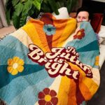 Phil Lester Instagram - If you need me I will be snug as a very long bug under this rug until further notice NEW MERCH!! Prepare to be almost too cozy under my new limited edition ‘future is bright’ handmade woven blanket! AND the most delicious smelling candle on earth - chocolate and toffee ‘treat yourself’ made in collab with @ohroslondon Available now with loads of other stuff on sale at amazingphilshop.com and us.amazingphilshop.com (combined with Dan shop and danandphilshop for the festive season!)🕯✨